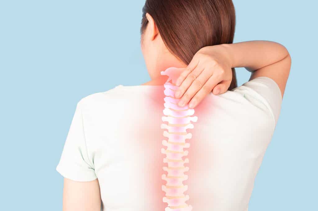Woman suffering from back pain and neck pain with anatomy of spine and xray for diagnosis over blue background. Common causes include injuries like inflammation of muscle ache or spinal stenosis.