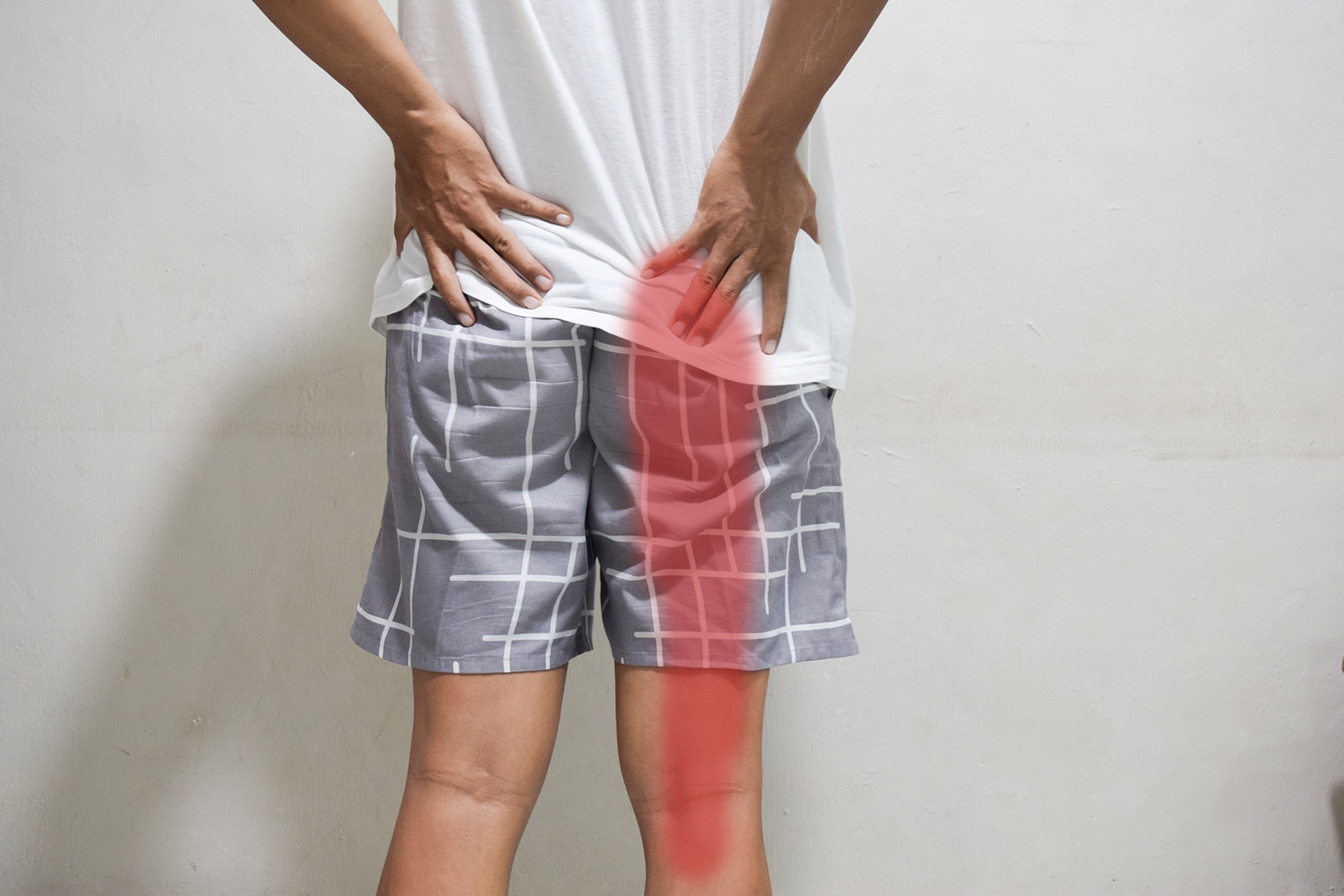 A patient experiencing leg pain that begins in the lower back.