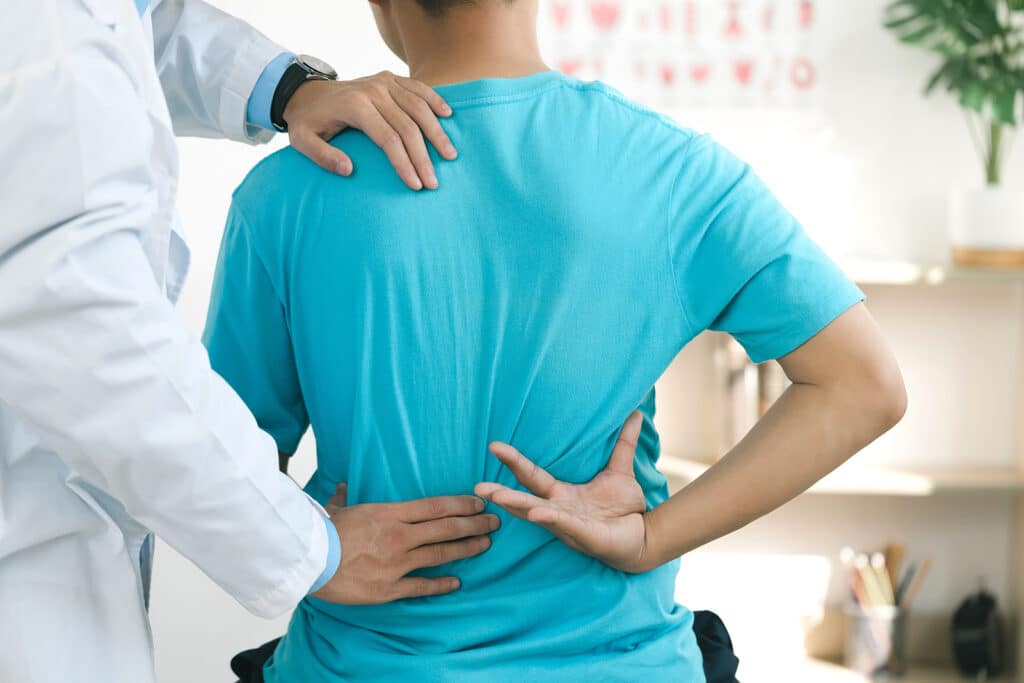 A man consulting a specialist for back pain.