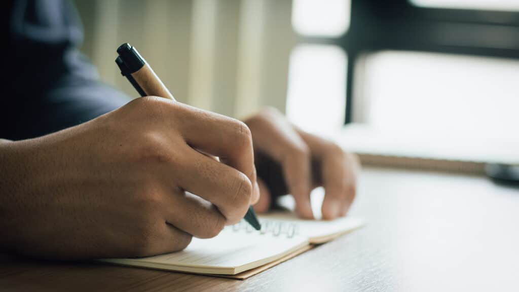 Man struggling with handwriting due to cervical myelopathy.