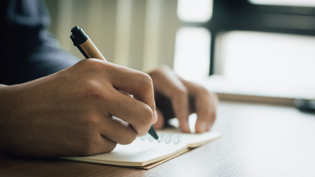 Man struggling with handwriting due to cervical myelopathy.
