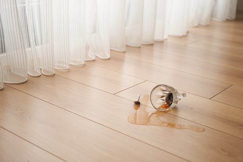 A spilt drink representing reduced grip strength as a possible sign of cervical spondylosis