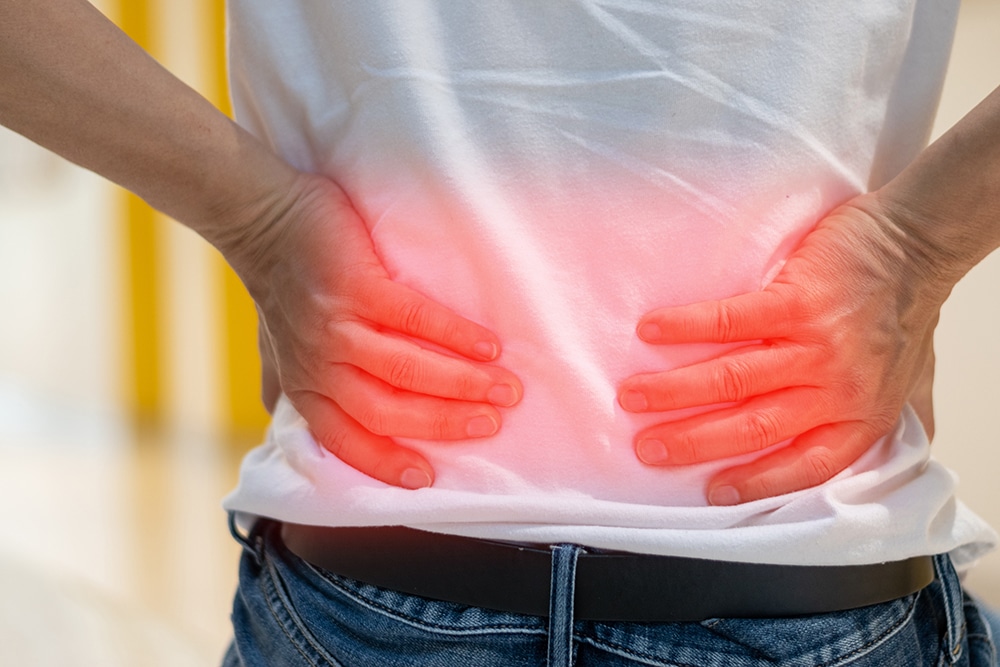 Male patient experiencing severe back pain, considering visiting a spine specialist.
