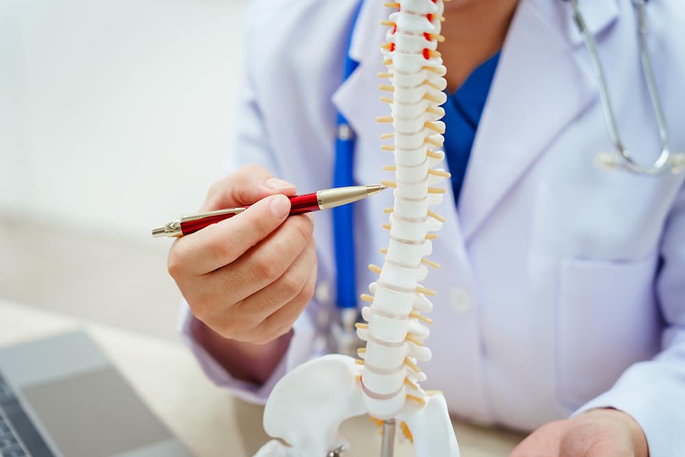Spine surgeon explaining about symptoms that require spine surgery to a patient.