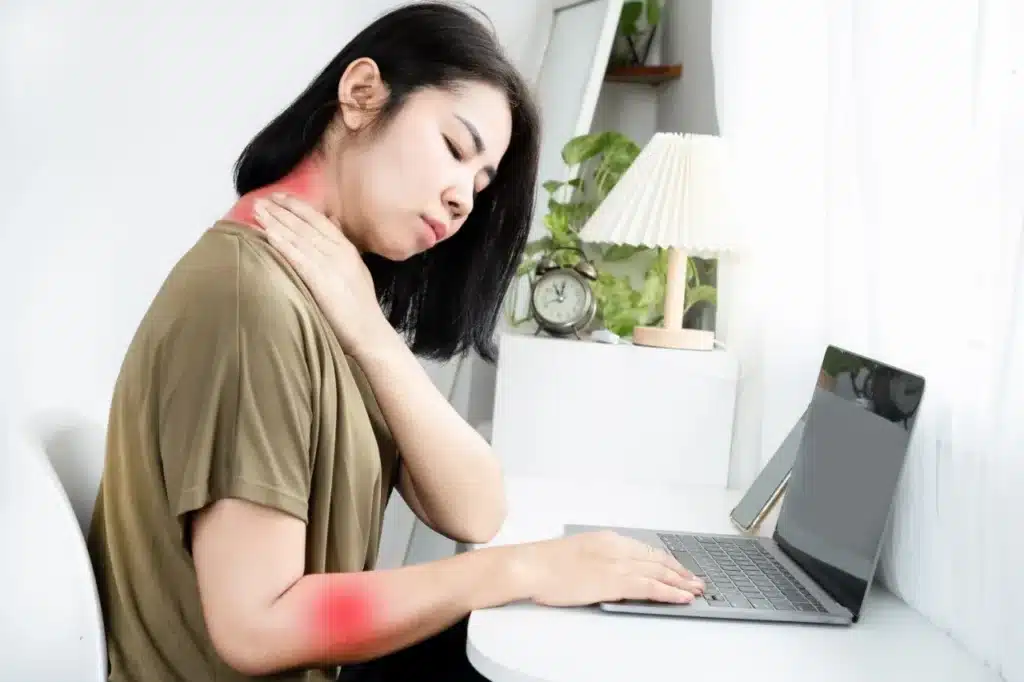 Woman experiencing pain in neck and arm