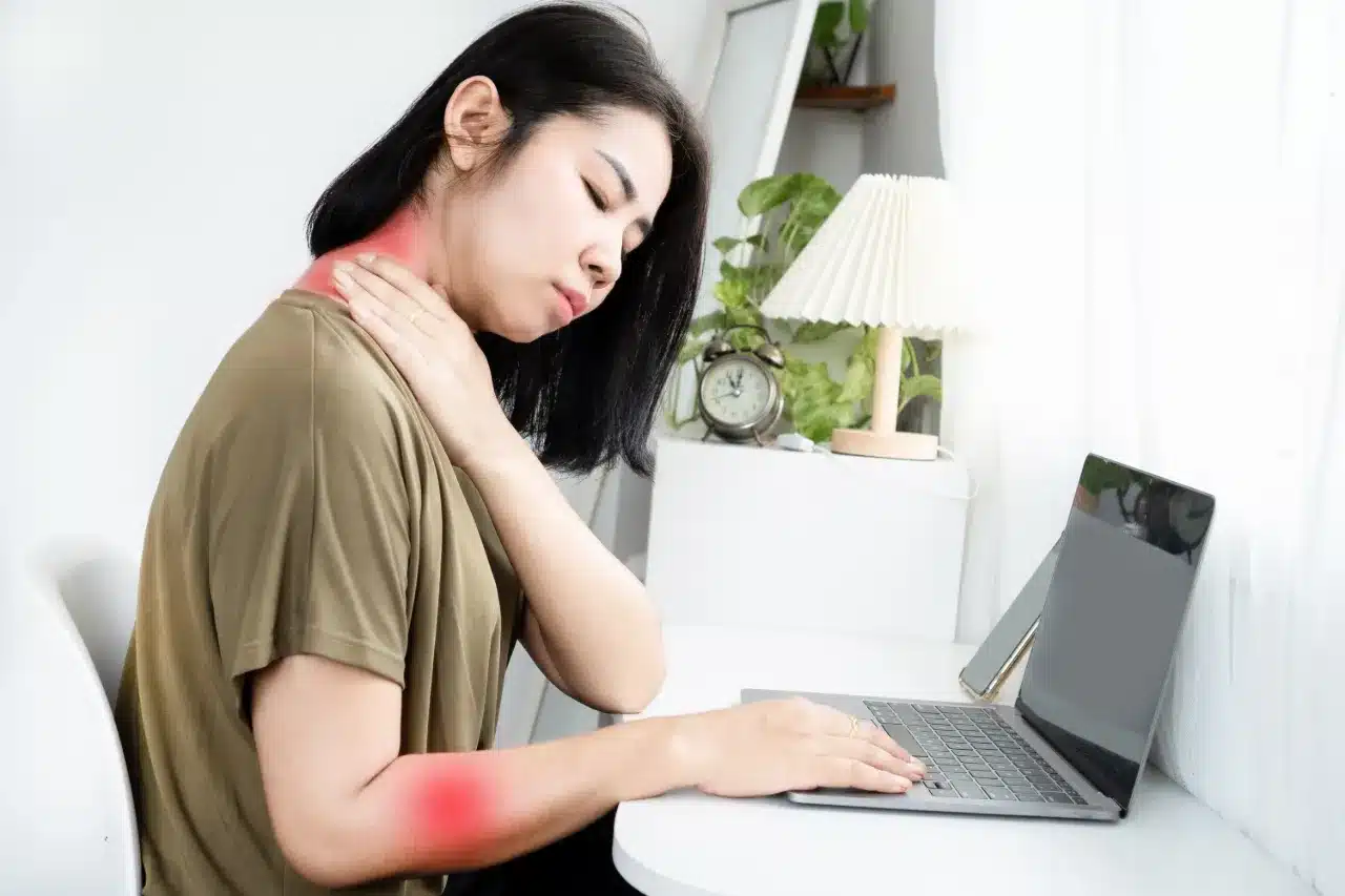 Woman experiencing pain in neck and arm