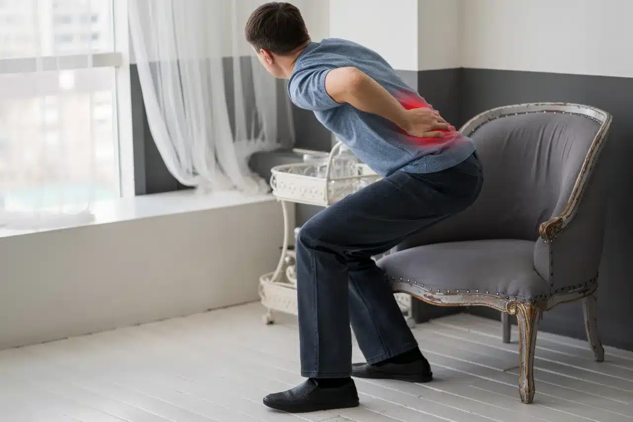 Man holding his lower back in pain due to a herniated disc