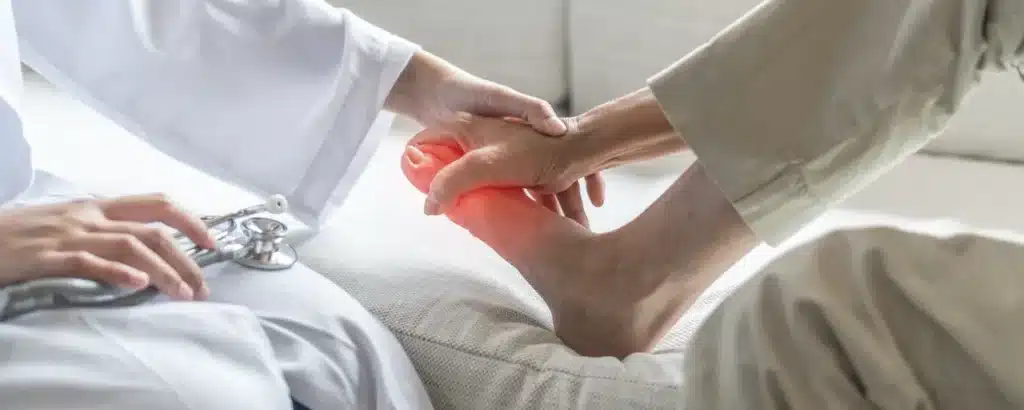 Patient getting her foot assessed by a specialist