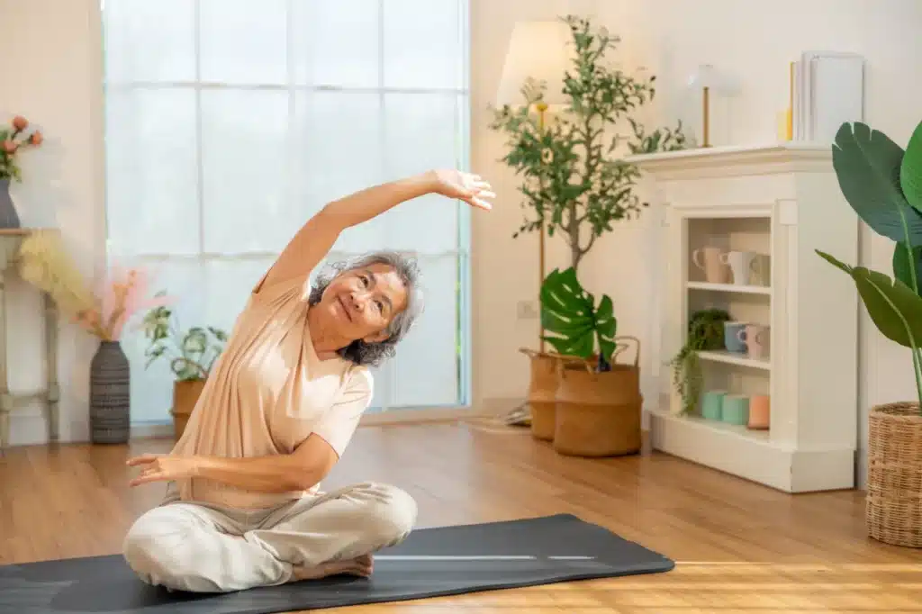 Elderly woman doing yoga exercise