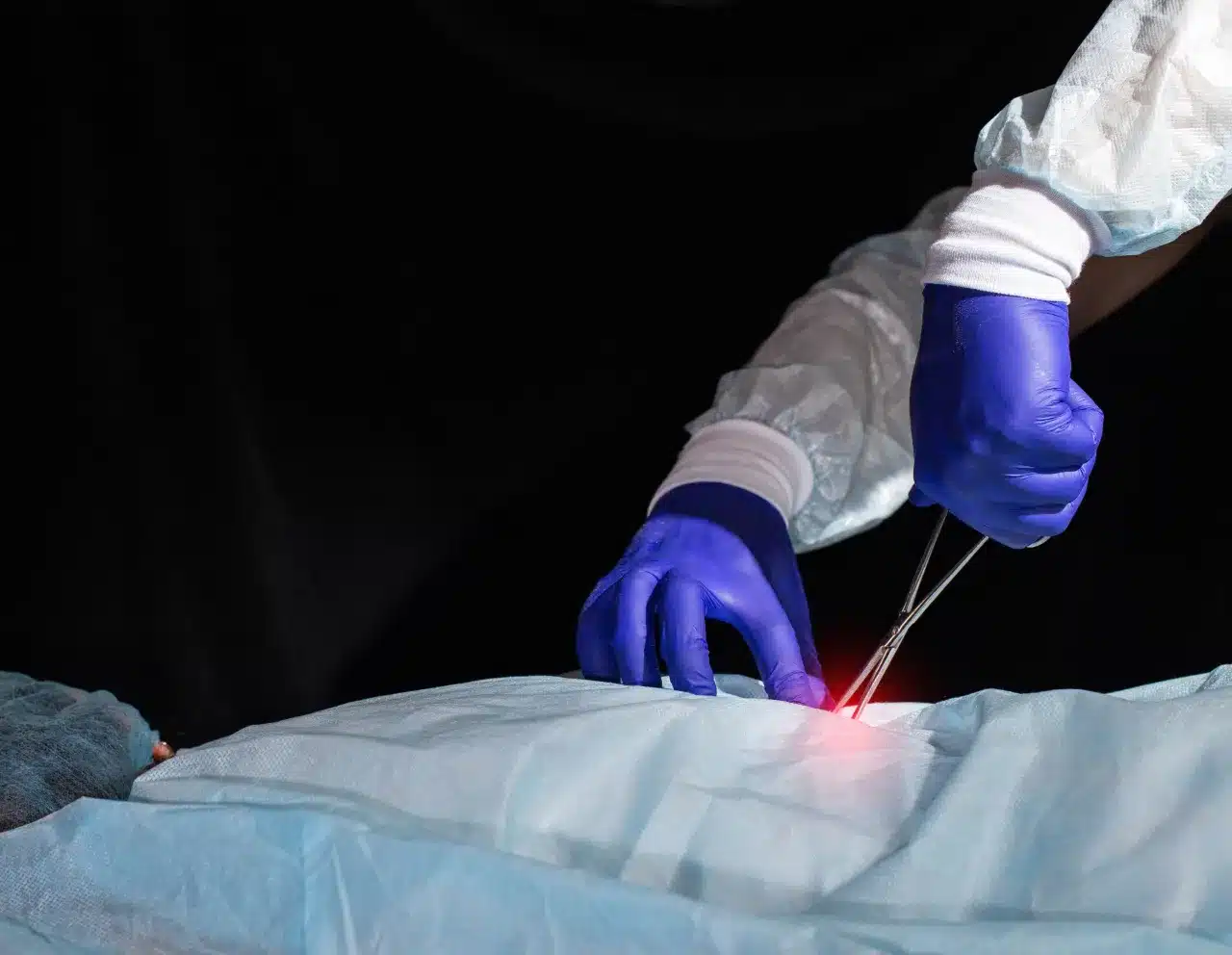Spinal surgeon performing surgery on his patient